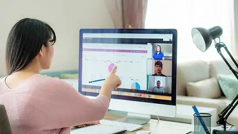 Asian business woman talking to her colleagues about plan in video conference. Multiethnic business team using computer for a online meeting in video call. Group of people smart working from home.