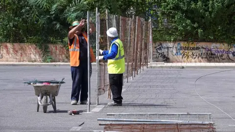 Trabajadores instalan un vallado.